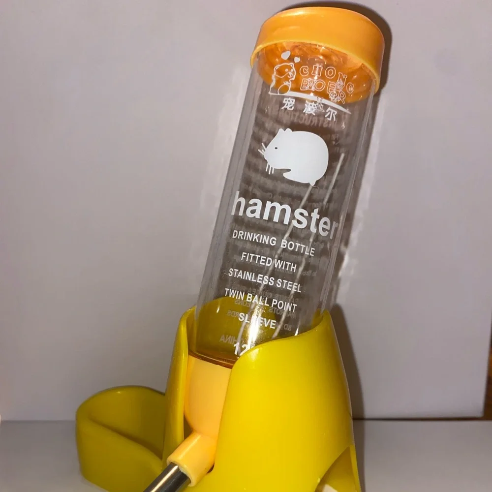 A yellow 3-In-1, (water bottle, feeding dish, and small hideout).